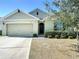 A well maintained single-story home with a two-car garage and manicured shrubs lining the front at 2312 Rose Blvd, Winter Haven, FL 33881