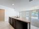 Modern kitchen featuring an island with a sink and an open view to the living area at 2312 Rose Blvd, Winter Haven, FL 33881