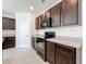 Well-lit kitchen featuring dark cabinets, modern appliances, tile flooring, and sleek countertops at 2312 Rose Blvd, Winter Haven, FL 33881
