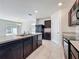 Open concept kitchen with island, dark wood cabinets, and stainless steel appliances, ideal for entertaining at 2312 Rose Blvd, Winter Haven, FL 33881