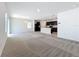 Bright, open-concept living area featuring carpet and views of the kitchen at 2312 Rose Blvd, Winter Haven, FL 33881