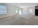Bright living room featuring neutral carpet, large windows, and a sliding door at 2312 Rose Blvd, Winter Haven, FL 33881