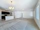 Open-concept space with neutral carpet, kitchen view, and ample natural light at 2312 Rose Blvd, Winter Haven, FL 33881