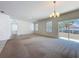 Bright living room with carpet, large windows, and sliding glass door for natural light at 2312 Rose Blvd, Winter Haven, FL 33881