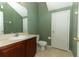 Bathroom showcasing an avocado green color scheme, vanity with sink, toilet, and a white door to the side at 2530 San Jacinto Cir # 2530, Sanford, FL 32771