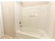 Bathroom tub and shower combo in a white tiled bathroom at 2530 San Jacinto Cir # 2530, Sanford, FL 32771