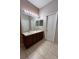 Bathroom with double sink vanity, tile floor, and a large mirror at 2530 San Jacinto Cir # 2530, Sanford, FL 32771