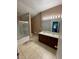 Well-lit bathroom with double vanity, tile floors, and a shower-tub combination at 2530 San Jacinto Cir # 2530, Sanford, FL 32771