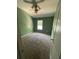 Bedroom with green walls, carpet flooring, a window and ceiling fan at 2530 San Jacinto Cir # 2530, Sanford, FL 32771