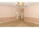 Bedroom featuring neutral colors, a ceiling fan, carpeted floors, and multiple doorways to other rooms at 2530 San Jacinto Cir # 2530, Sanford, FL 32771