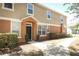 Front exterior of a two-story townhouse with an orange and beige color scheme at 2530 San Jacinto Cir # 2530, Sanford, FL 32771