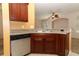 Kitchen with wooden cabinets, stainless steel dishwasher and sink at 2530 San Jacinto Cir # 2530, Sanford, FL 32771