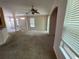 Open living room with carpet, fan and multiple windows for natural light at 2530 San Jacinto Cir # 2530, Sanford, FL 32771