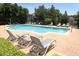 Community pool area with lounge chairs and a view of the surrounding landscape at 2530 San Jacinto Cir # 2530, Sanford, FL 32771