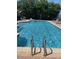Sparkling community pool with lounge chairs for relaxation on a sunny day at 2530 San Jacinto Cir # 2530, Sanford, FL 32771