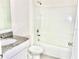 Clean bathroom with granite vanity, white toilet, and shower-tub combination with tile surround at 2637 Rowan St, Tavares, FL 32778