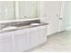 Elegant bathroom with dual sink vanity, granite countertop, and a large mirror over modern fixtures at 2637 Rowan St, Tavares, FL 32778