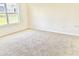 Comfortable bedroom features soft carpeting, neutral walls, and a bright window offering natural light at 2637 Rowan St, Tavares, FL 32778
