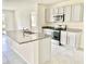 Open kitchen with granite countertops, stainless steel appliances, island, and ample cabinet space at 2637 Rowan St, Tavares, FL 32778