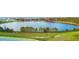 Scenic lake view featuring lush greenery, trees and waterfront homes in the distance, creating a tranquil and picturesque setting at 2637 Rowan St, Tavares, FL 32778