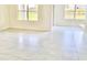 Bright living room features tile floors, neutral walls, and plenty of natural light from large windows at 2637 Rowan St, Tavares, FL 32778
