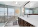 Bathroom with white marble countertop, dark wood cabinets and walk-in shower at 2704 Gorst Rd, Winter Garden, FL 34787