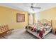 Bedroom with yellow walls, colorful quilt, and a contemporary chair at 2704 Gorst Rd, Winter Garden, FL 34787