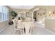 Elegant dining room featuring neutral color palette, white furniture, and a decorative rug at 2704 Gorst Rd, Winter Garden, FL 34787