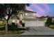 Charming two-story home with a three car garage and well-manicured lawn and landscaping at 2704 Gorst Rd, Winter Garden, FL 34787