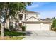 Two-story home with a three car garage, mature trees and landscaping in the front yard at 2704 Gorst Rd, Winter Garden, FL 34787