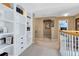 Upstairs hallway featuring carpet flooring and built-in shelving at 2704 Gorst Rd, Winter Garden, FL 34787