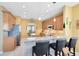 Spacious kitchen features granite counters, a breakfast bar with seating, stainless steel appliances and tile flooring at 2704 Gorst Rd, Winter Garden, FL 34787