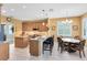 Bright eat-in kitchen features stainless appliances, a breakfast bar, tile flooring, and a breakfast nook with seating at 2704 Gorst Rd, Winter Garden, FL 34787