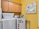 Laundry area with stacked washer and dryer and upper cabinets at 2704 Gorst Rd, Winter Garden, FL 34787