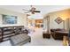 Spacious living room with ceiling fan and comfortable seating arrangement, leading to the staircase and kitchen at 2704 Gorst Rd, Winter Garden, FL 34787
