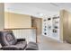 Loft area with a comfortable chair, built-in shelving, and neutral carpeting at 2704 Gorst Rd, Winter Garden, FL 34787