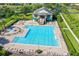 Aerial view of a large community pool, clubhouse, and well-manicured landscaping at 2704 Gorst Rd, Winter Garden, FL 34787