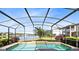 Gorgeous screened-in pool with water view and lush landscaping, perfect for relaxation at 2704 Gorst Rd, Winter Garden, FL 34787