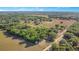 Acreage with a home, outbuildings, and scattered trees across a vast field, as seen from above at 36208 Micro Racetrack Rd, Fruitland Park, FL 34731