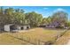 Aerial shot of property with home, outbuildings and fencing surrounded by trees at 36208 Micro Racetrack Rd, Fruitland Park, FL 34731
