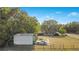 Aerial shot of a home, detached garages, and large front yard at 36208 Micro Racetrack Rd, Fruitland Park, FL 34731