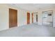 Spacious bedroom with plush carpeting, featuring mirrored closet doors and multiple closets at 36208 Micro Racetrack Rd, Fruitland Park, FL 34731