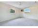 Bright bedroom with ample natural light, featuring soft carpeting and picturesque outdoor views at 36208 Micro Racetrack Rd, Fruitland Park, FL 34731