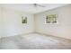 Comfortable bedroom featuring neutral walls, carpeted flooring, and ample natural light at 36208 Micro Racetrack Rd, Fruitland Park, FL 34731
