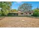 Brick home with a screened-in porch and spacious yard presents a comfortable setting at 36208 Micro Racetrack Rd, Fruitland Park, FL 34731