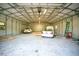 A large, well-lit metal garage interior has room for two cars and other equipment at 36208 Micro Racetrack Rd, Fruitland Park, FL 34731
