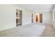 Open-concept living room with doorways and neutral carpet at 36208 Micro Racetrack Rd, Fruitland Park, FL 34731