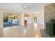 Open-concept living room with fireplace, leading to an enclosed porch, for seamless indoor-outdoor living at 36208 Micro Racetrack Rd, Fruitland Park, FL 34731