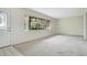 Bright living room with large window and neutral carpet flooring at 36208 Micro Racetrack Rd, Fruitland Park, FL 34731