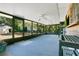 Spacious screened porch perfect for outdoor entertaining, with views of mature trees and greenery at 36208 Micro Racetrack Rd, Fruitland Park, FL 34731